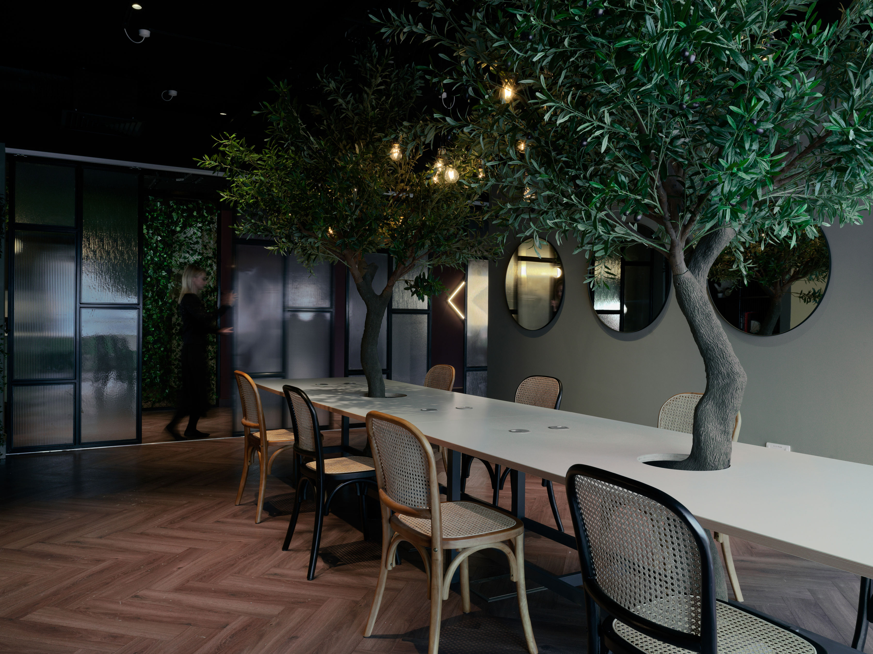 Co-working bench desk with olive trees growing through it