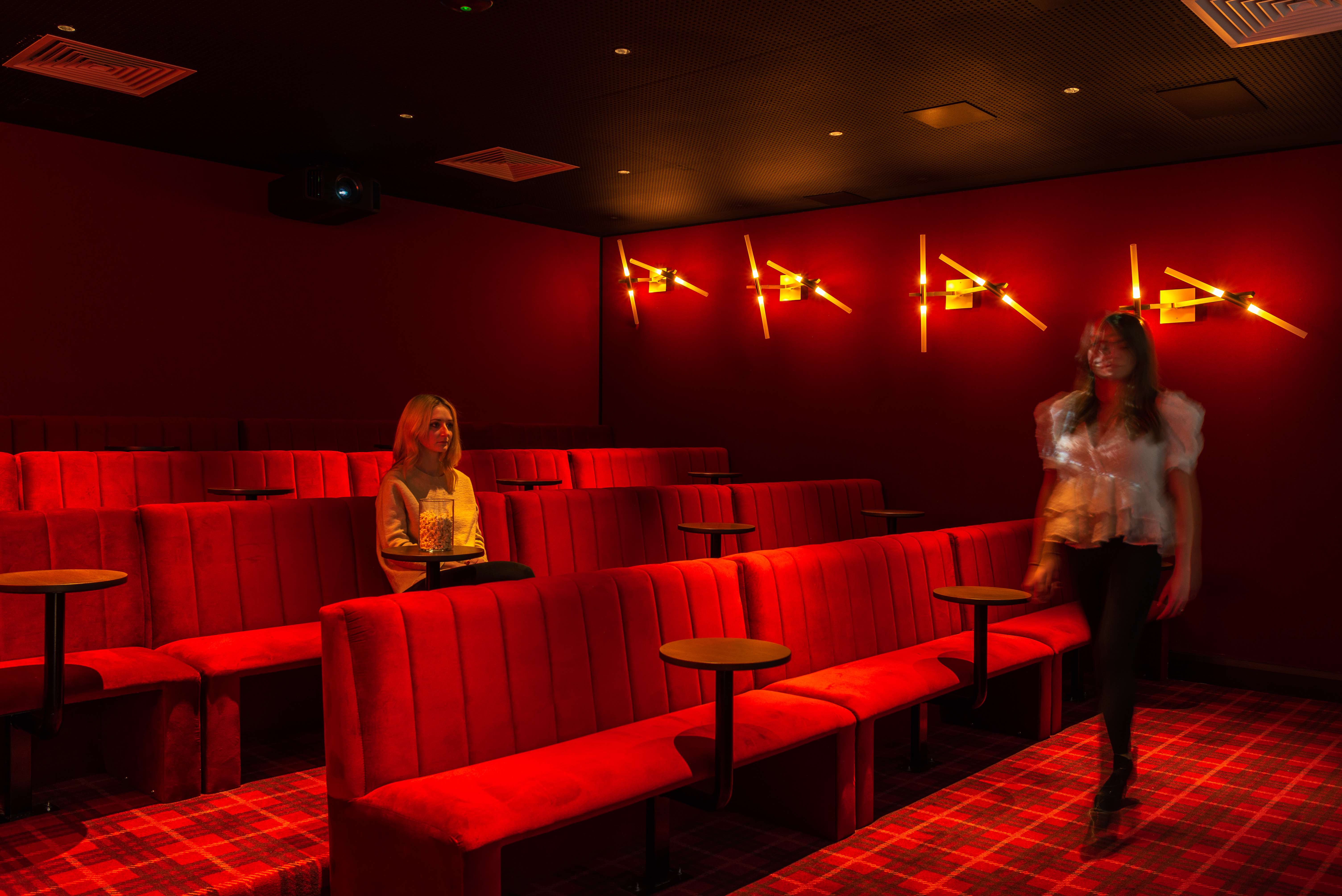 Private cinema room with red velvet seating