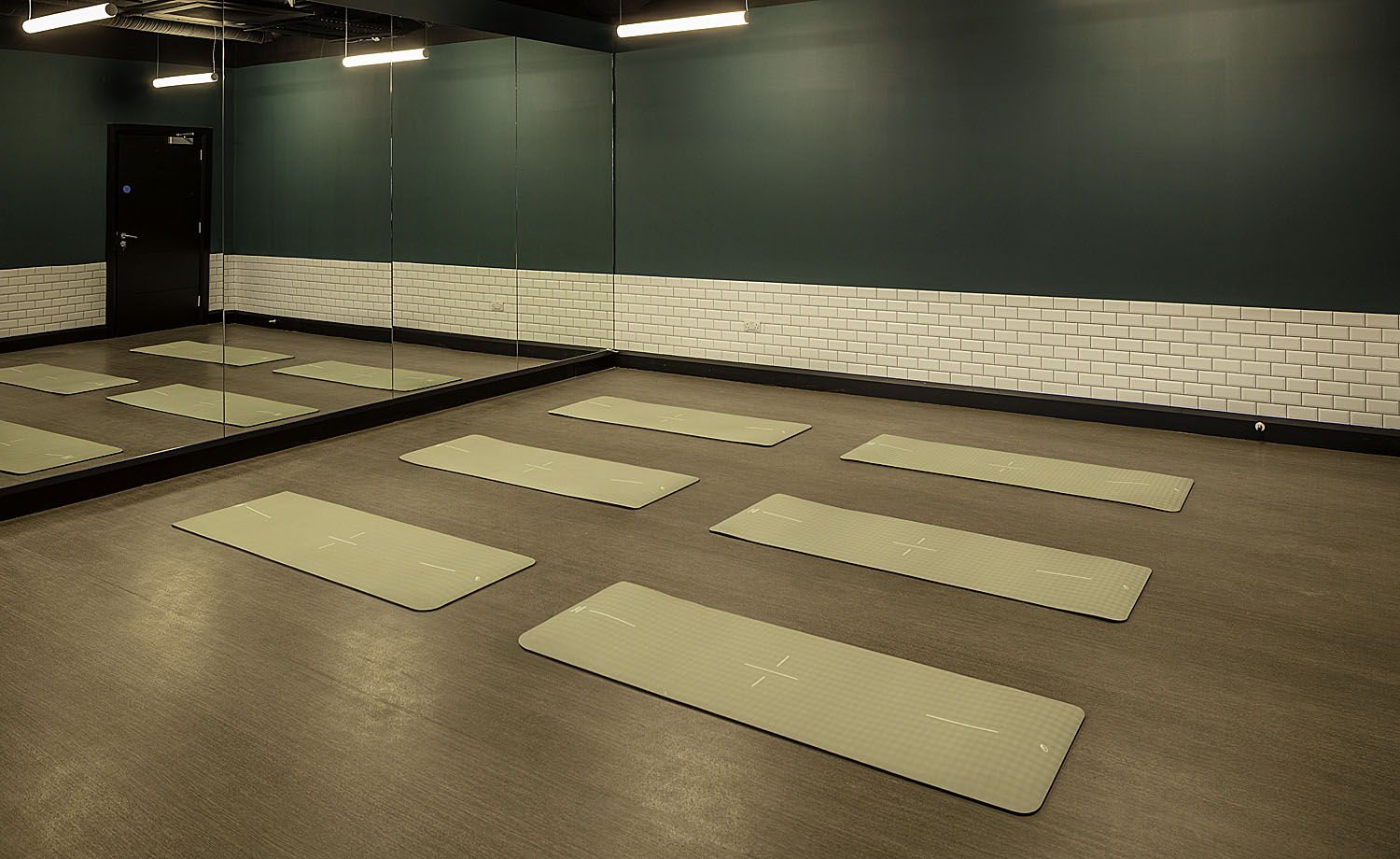 Spin studio with indoor cycling bikes and mirrored wall