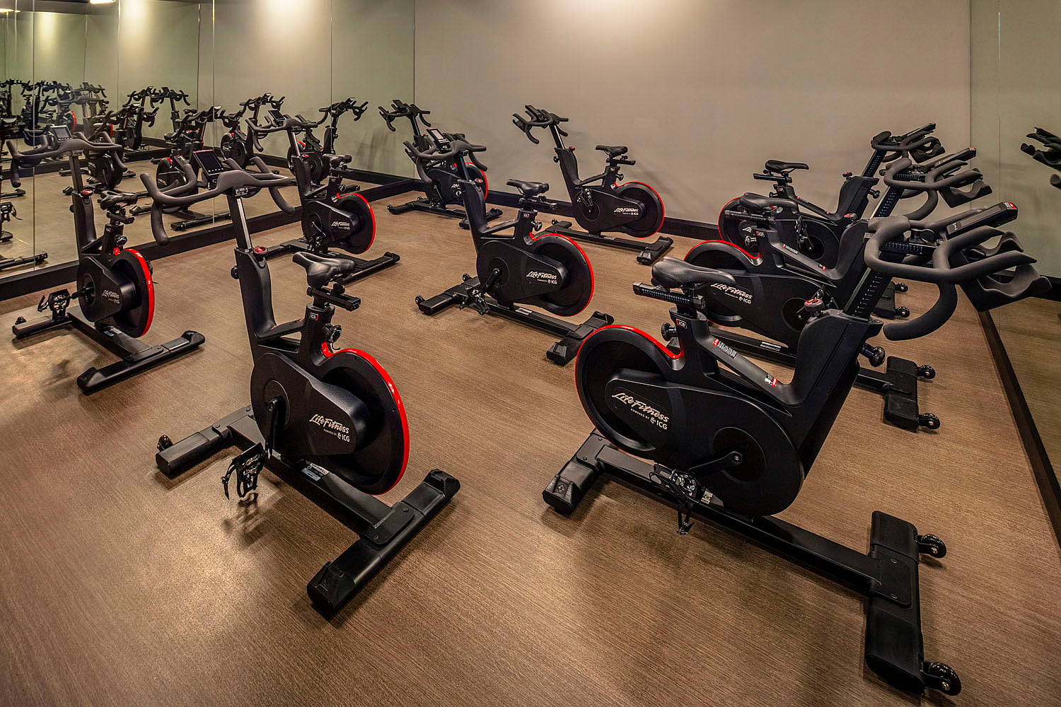 Studio for yoga and fitness classes with mats and full-length mirrors