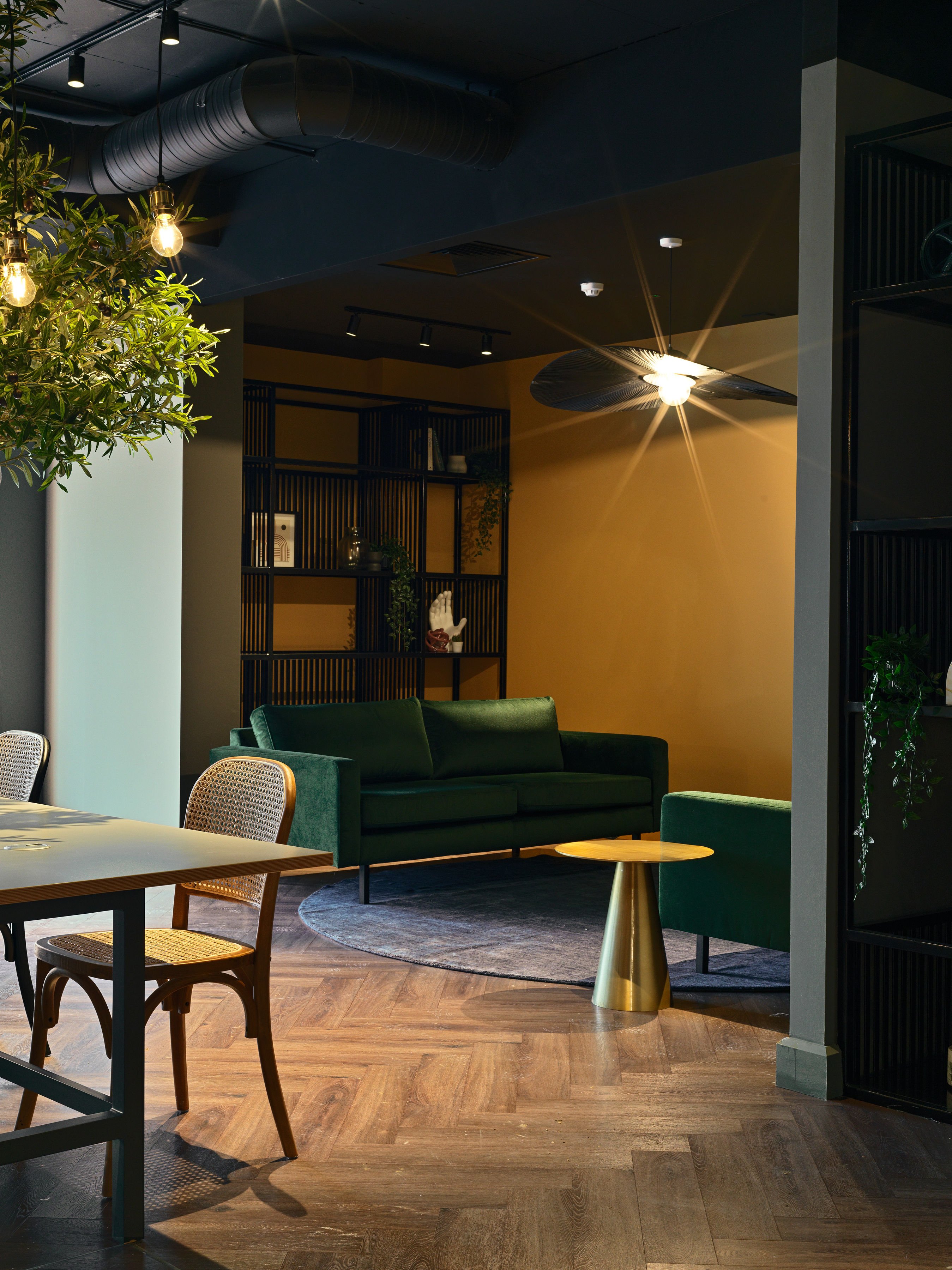 Snug with green velvet sofas and warm ochre walls